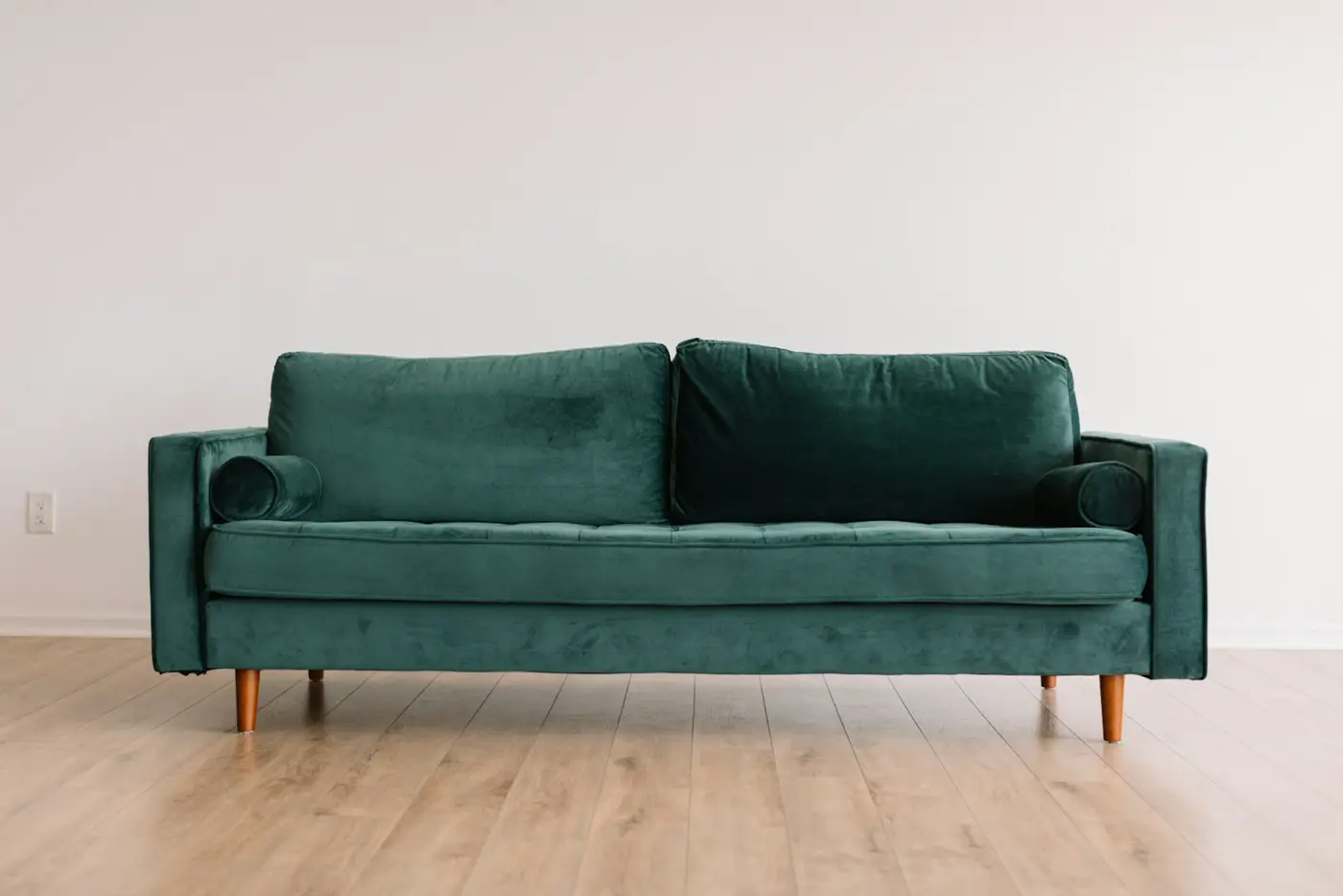 Illustrative photo of a green sofa in a living room. Not Central Rentals stock.